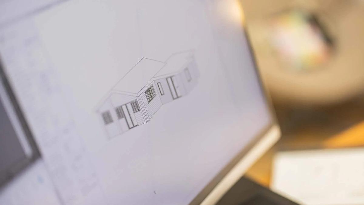 Skærmbillede af en computer, der viser en 3D-model af et husdesign med detaljerede linjer og perspektiv.