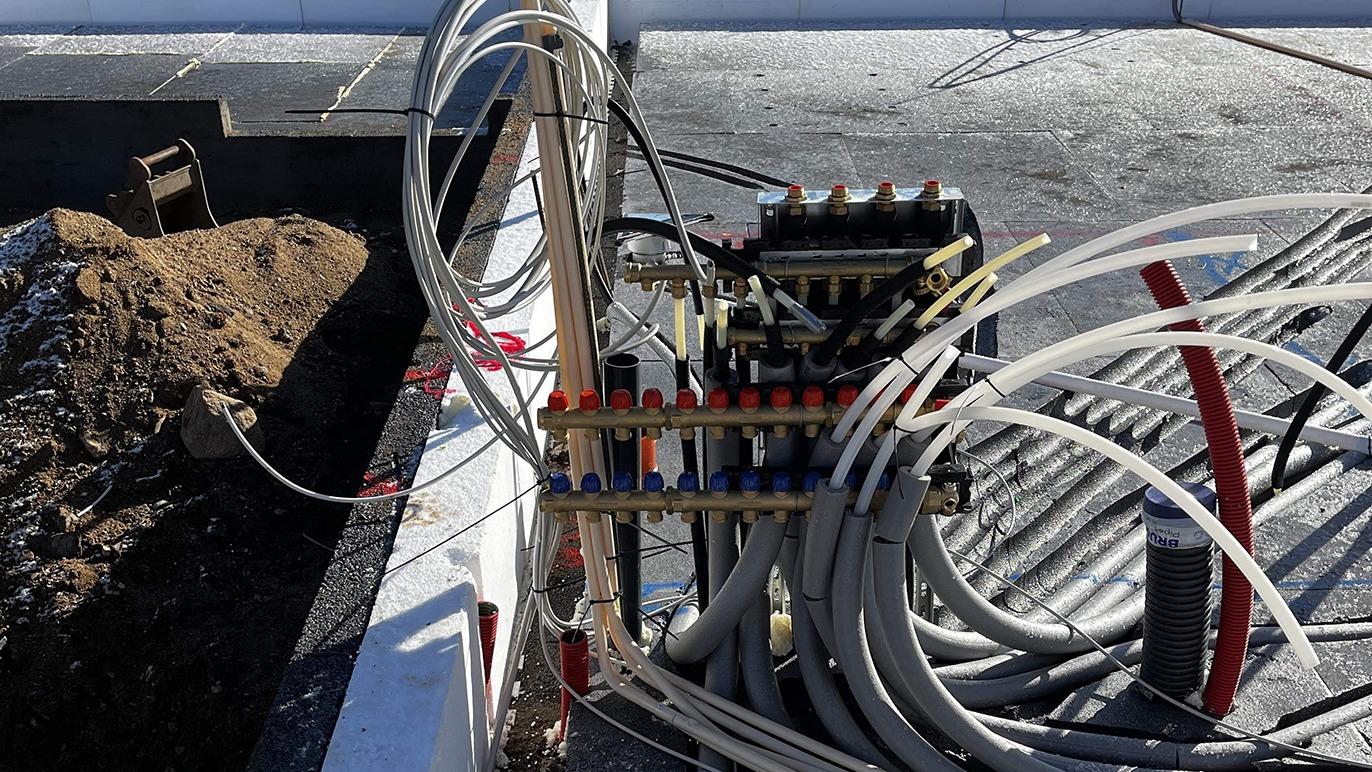Billede af et rørsystem med slanger og ventiler til installation på en byggeplads.
