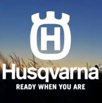 Husqvarna logo med teksten "Ready When You Are" på en baggrund af blå himmel og kornmarker.